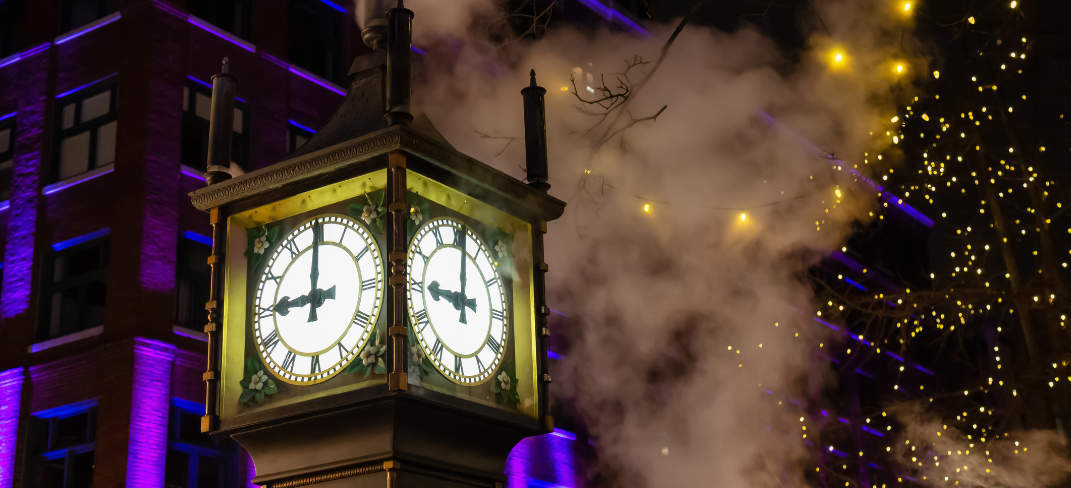A clock tower lit up at night 